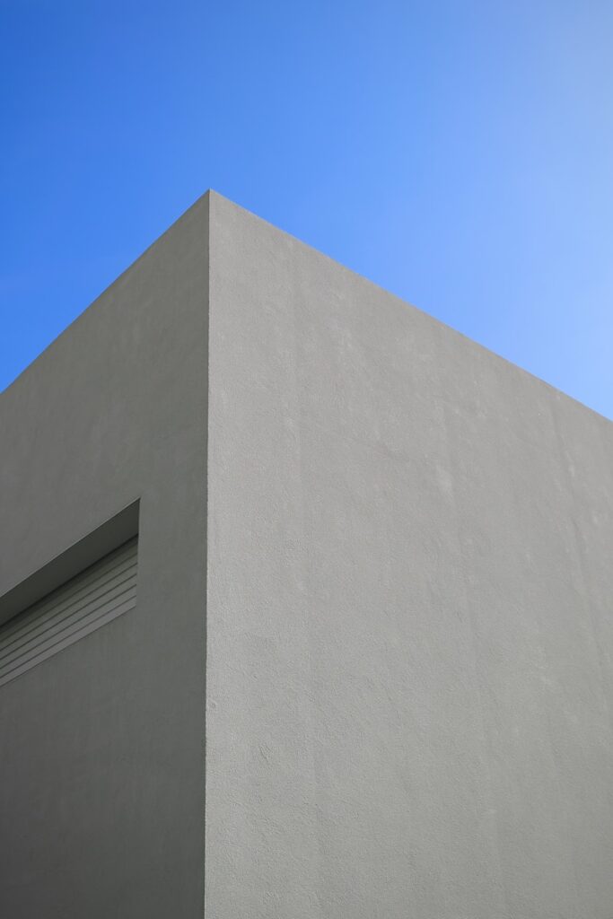 A white building with a blue sky in the background